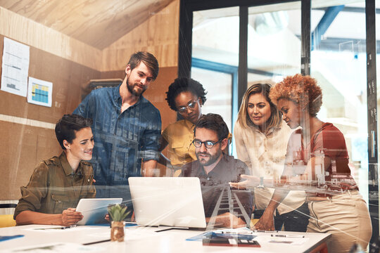 Combining their skills and efforts to drive success forward. Multiple exposure shot of businesspeople having a meeting superimposed over a cityscape.