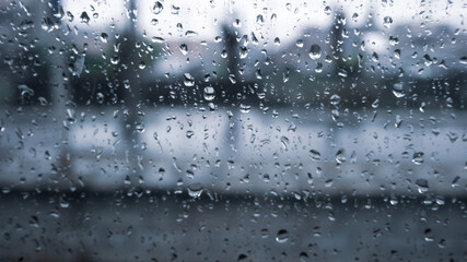 Blurry Raindrops on Station Window During Evening Shower