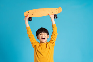 Asian boy portrait posing on blue background