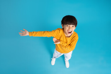 Asian boy portrait posing on blue background