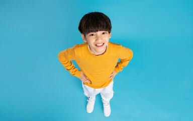 Asian boy portrait posing on blue background