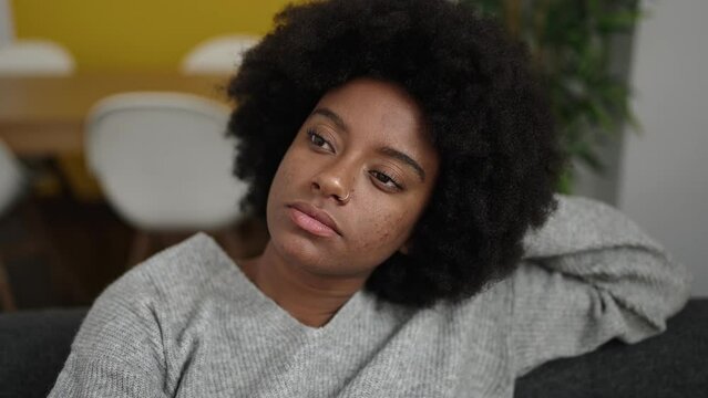 African american woman relaxed on sofa at home