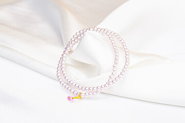 pearl necklace with white satin background