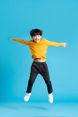 Fototapeta na wymiar full body image of asian boy posing on blue background