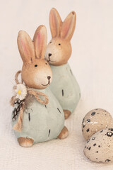 Two Easter rabbits, two eggs on white background. Easter composition, copy space