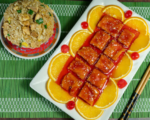 kam lu wantan with orange pieces and chaufa rice. Peruvian Chinese food. Chifa