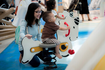 Mother and baby at playground in mall