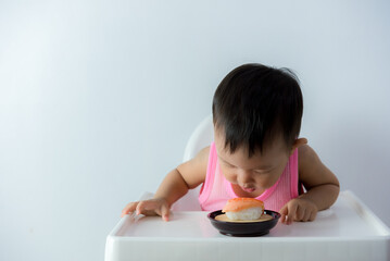 Baby boy with sushi on food chair, Cute baby hungry sitting in a chair