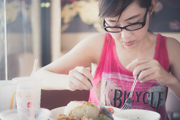 Closeup asian woman eating in a restaurant