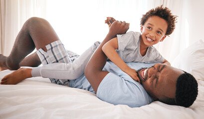 Black family, play and father with son on bed for bonding, quality time and relaxing together in...