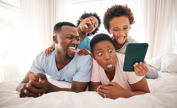 Selfie, funny and black family on the bed with a tablet for communication, memory and comedy. Crazy, comic and African children taking a photo on tech with parents for bonding and quality time