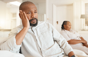 Stress, depression and divorce of black man on sofa in home living room thinking after fight....