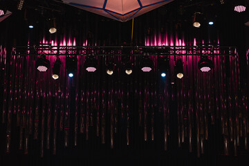 Stage lights in front of organ pipes on stage