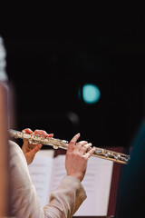 A musician playing the flute during in a wind band rehearsal
