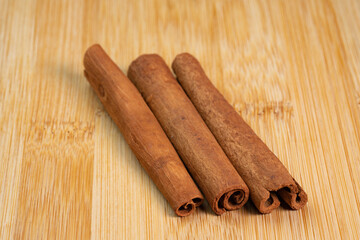 Cinnamon sticks on a wooden background. Fragrant cinnamon seasoning close-up. Spices with cinnamon. Food cooking video concept. ingredients for warm wine, mulled wine