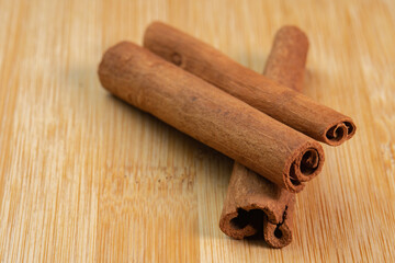 Cinnamon sticks on a wooden background. Fragrant cinnamon seasoning close-up. Spices with cinnamon. Food cooking video concept. ingredients for warm wine, mulled wine