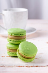 Three green macaroons on a light background
