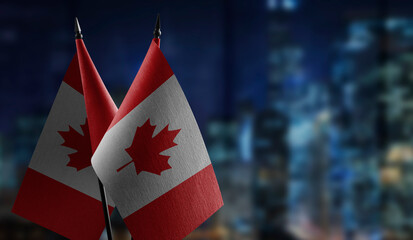 Small flags of the Canada on an abstract blurry background