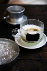 Creamy salted phin coffee cup served with bowl of ice                                