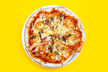 Pizza on yellow background. Top view
