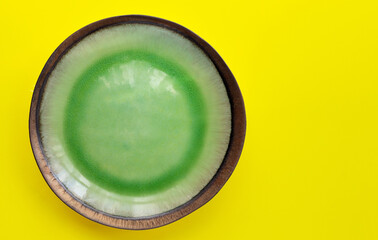 Green plate on yellow background.