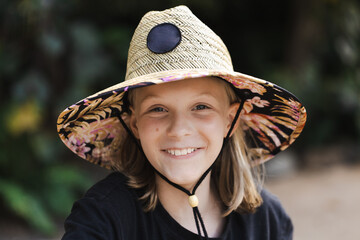 A young australian 11 year old girl wearing a sun smart wide brimmed hat
