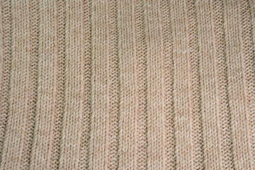 Knitted warm white fabric or sweater. Cozy textile background in the home atmosphere. Wool fabric texture close up backdrop. Comfortable style clothing. Wavy folds material