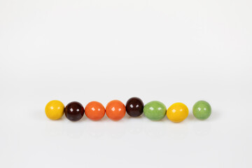 Colorful chocolate balls arranged in a row.
