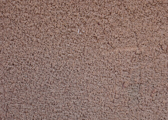 Fototapeta na wymiar Wall background, grainy brown plaster, concrete texture, close-up. High quality photo. Brown wall