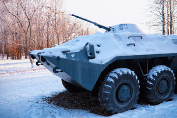 Tank under the snow in the forest. Winter tank camouflage. Battle tank in the snow on the roadside...