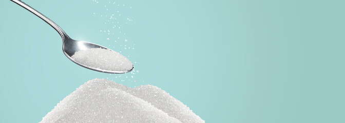 heap of sugar being picked up by a spoon