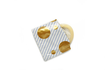 Opened condom in pack isolated on white background. A condom use to reduce the probability of...
