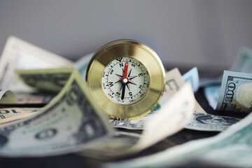 Money bill with golden Compass. Bullets and cartridge cases as a military concept. Close up US Currency and compass. business, financial idea, concept, symbol of crisis, inflation