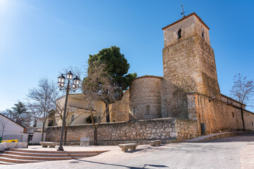 Old stone church with bell tower in the medieval village of Pezuela Torres, Madrid.
