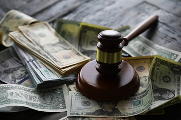 Fototapeta na wymiar judge gavel and money on brown wooden table concept