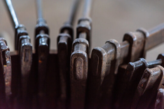 Screw clamps, fixed at a piece of iron pipe, in the workshop of a shipyard in the industrial area of the port of Hamburg

