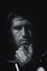 a black-and-white portrait of a working-class man