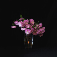flowers in a vase on a dark background