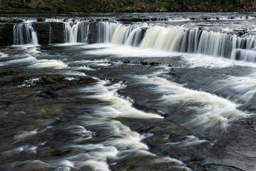 Beautiful dramatic landscape image of Aysgarth Falls in Yorkshire Dales in England during Winter morning