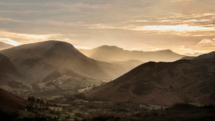 Absolutely wonderful landscape image of view across Derwentwater from Latrigg Fell in lake District during Winter beautiful colorful sunset