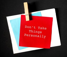 Note with cloth pin on black background, means not to be offended or upset by what someone said,...