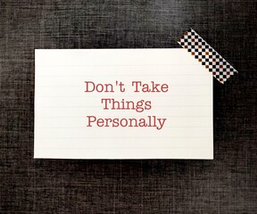 Note on black background with text written Dont Take Things Personally, means not to be offended or...