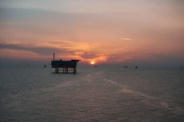 Fototapeta na wymiar Electricity transformation station for wind turbines at sea at sunrise.