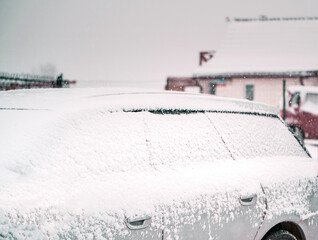 Var fully covered in snow during severe snow storm. A snow-covered vehicle in winter.
