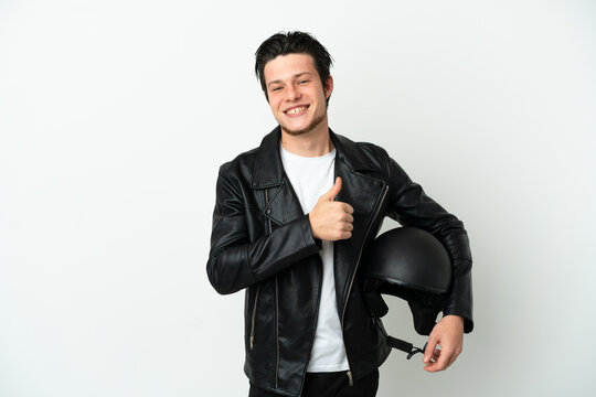 Russian man with a motorcycle helmet isolated on white background giving a thumbs up gesture