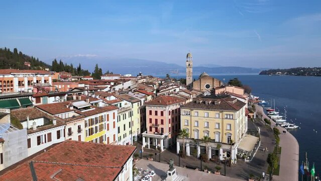Europe, Italy, Brescia , Garda lake , Salo' drone aerial view of  village with church and lake with blue water - Italian  Republic from 1943 to 1945 during the reign of Benito Mussolini fascist 