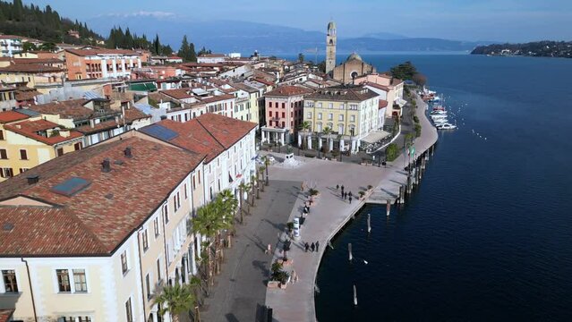 Europe, Italy, Brescia , Garda lake , Salo' drone aerial view of  village with church and lake with blue water - Italian  Republic from 1943 to 1945 during the reign of Benito Mussolini fascist 
