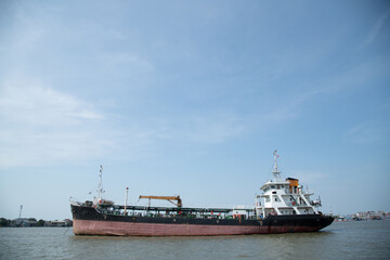 Naklejka premium cargo ship on open water bay blue sky