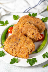 Frying rice and minced meatballs on the gray floor. Turkish women meatballs or kadınbudu kofte. Turkish appetizer varieties. Close up