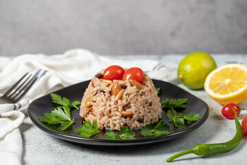 Rice rice with pine pistachios and almonds on a gray floor. Bademli ic pilavı. Appetizer varieties. Ramadan food